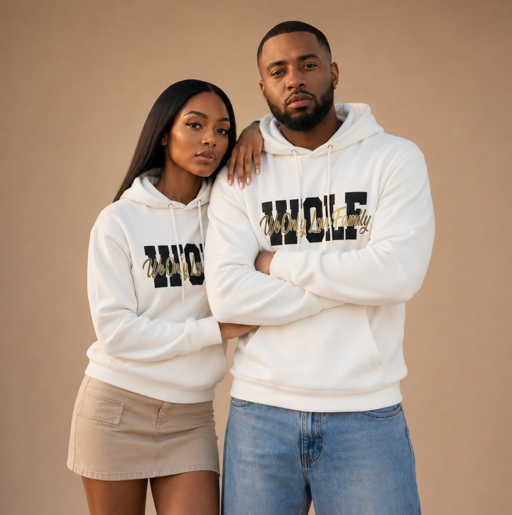Man and woman wearing matching white WOLF sweatshirts with navy logo branding.