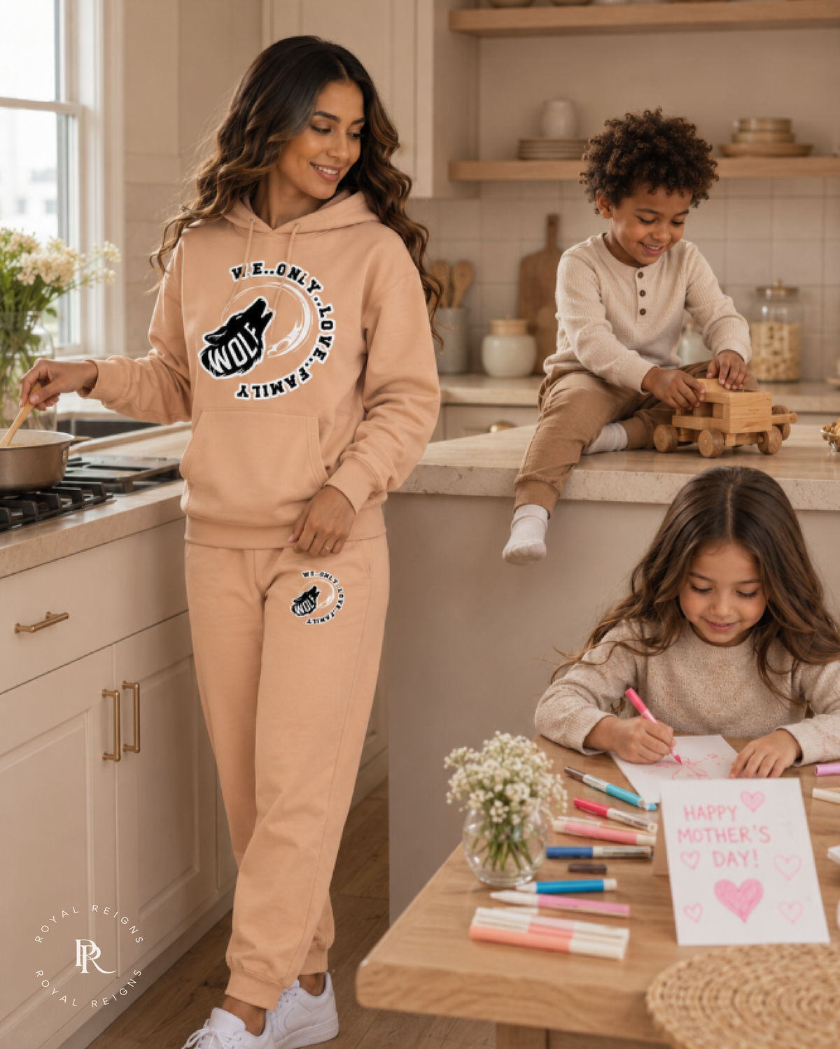 Woman wearing the WOLF signature hoodie and sweatpantsset in a kitchen with children