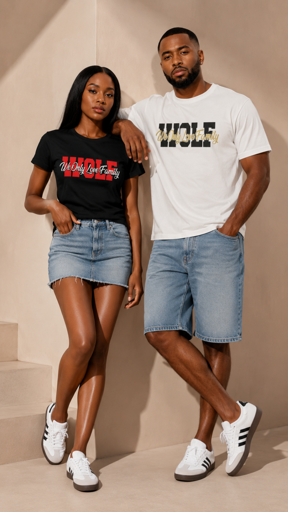 Two people standing together wearing matching WOLF t-shirts and denim shorts on a beige background