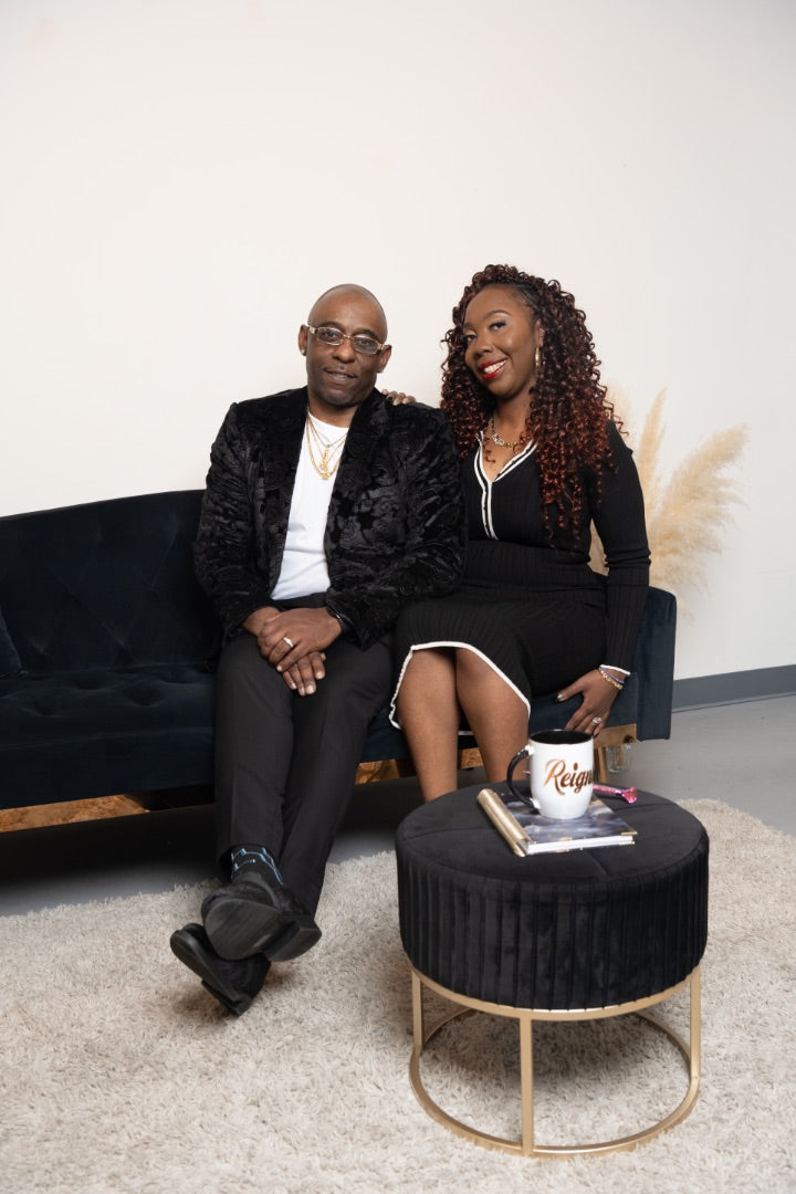 George and Essence Myrick, founders of Royal Reigns Design, seated together in their studio.