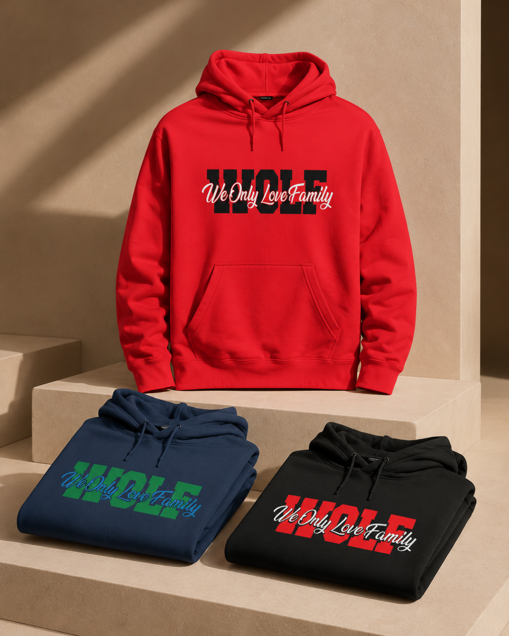 Red WOLF hoodie displayed with folded navy and red branded WOLF hodies on a beige background.