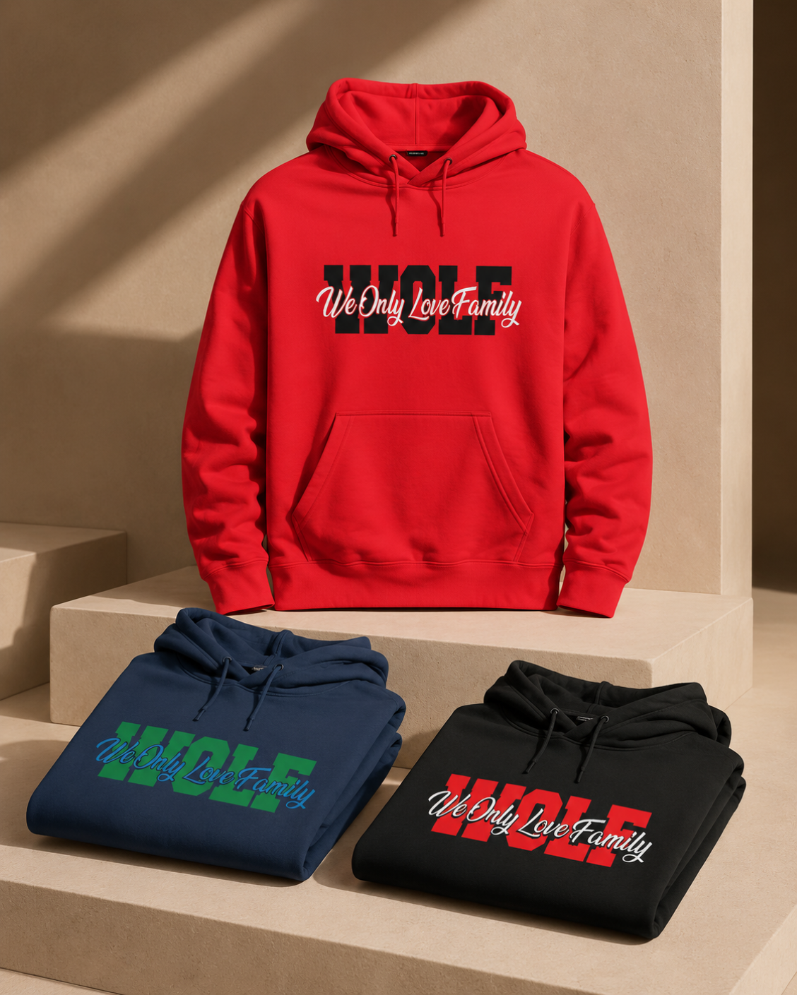 Red WOLF hoodie displayed with folded navy and red branded WOLF hodies on a beige background.